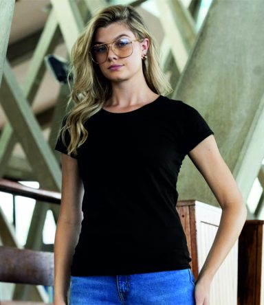 Woman with long blonde hair wearing a black t-shirt and glasses, posing indoors.